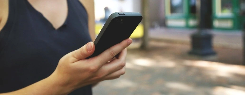woman holding a phone about to convert on mobile.