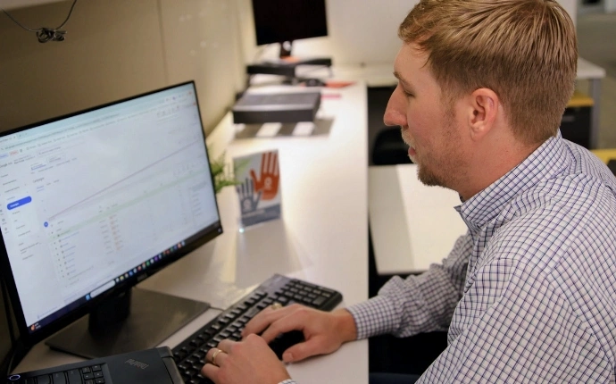 Google Analytics expert reviewing GA4 reporting data at an OuterBox workstation