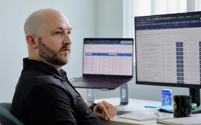 A developer with the OuterBox WordPress web design agency working on a computer.