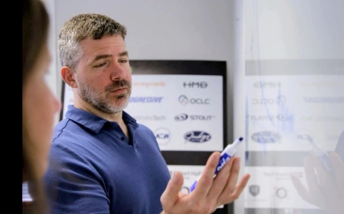 Man in a blue polo shirt working at OuterBox Digital Marketing Agency for small businesses.