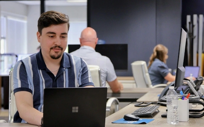 OuterBox web development team working at laptops in the agency office