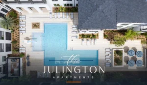 RISE Julington apartment community in Jacksonville, FL, showing the resort-style pool deck with the property's official The Julington wordmark