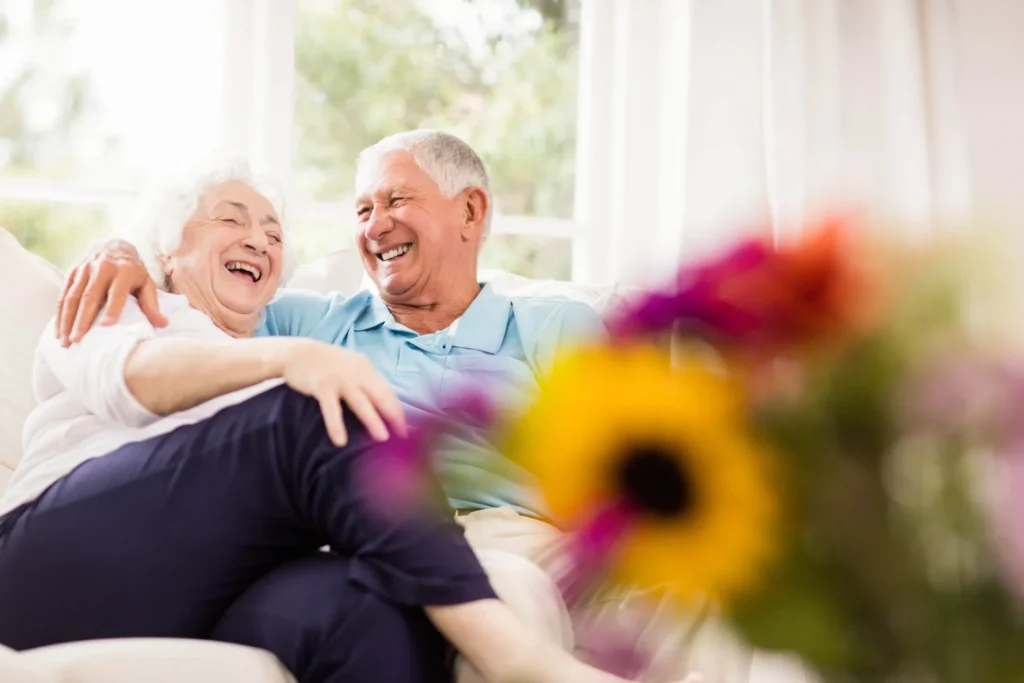 Senior couple relaxing together in a bright, sunlit senior-living residence
