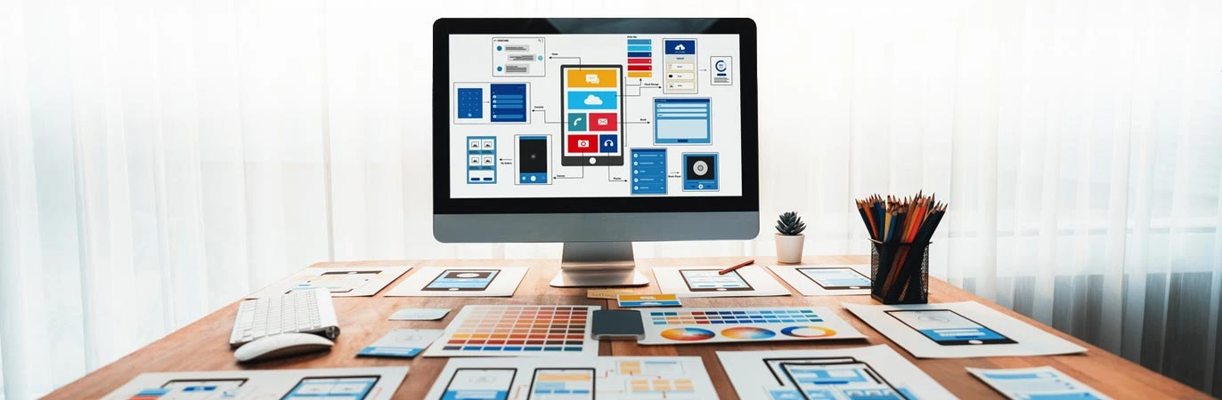 Desktop workspace with website wireframes for turning website audit findings into a redesign roadmap