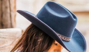 Woman wearing a navy cowboy hat from American Hat Makers