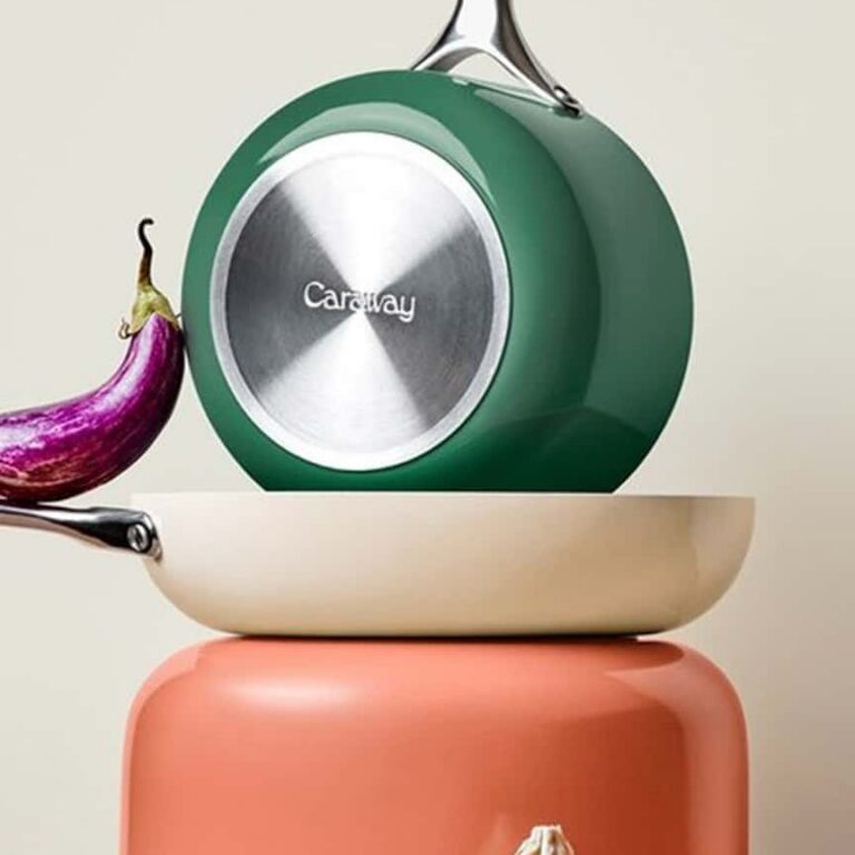 Green, cream, and coral Caraway cookware stacked together