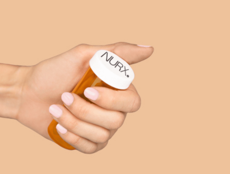 Hand holding a NURX prescription bottle