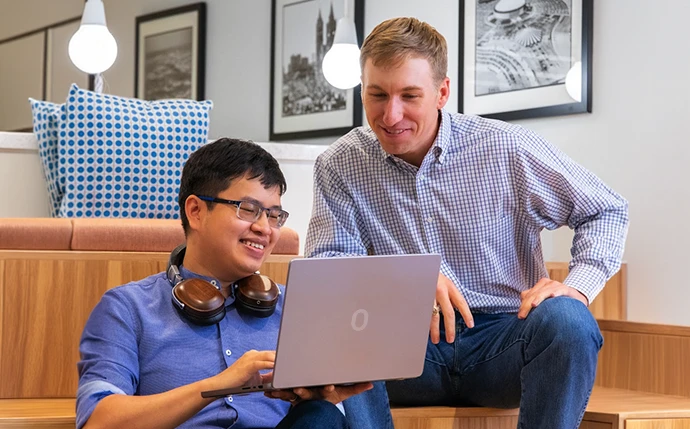 OuterBox Mailchimp consultants reviewing email marketing strategy and program planning on a laptop
